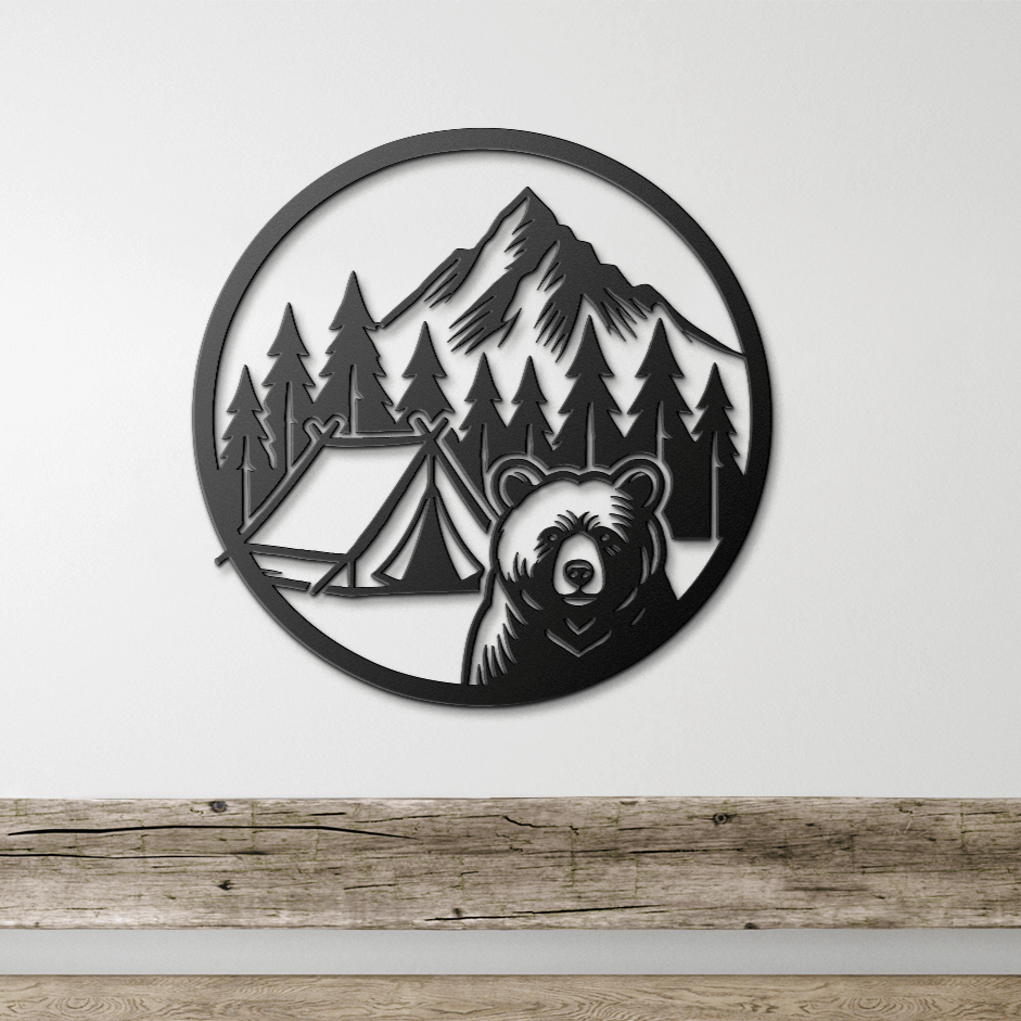 Black metal wall art depicting a bear, camping tent, trees, and mountain in a circular design