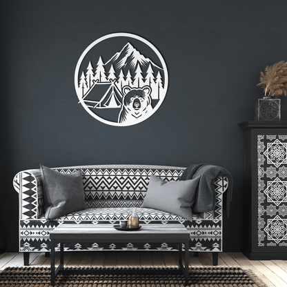 Bear camping metal wall art on dark wall above a patterned sofa, adding nature-themed decor to the living space.