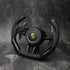 Black steering wheel with Porsche logo on a dark gray background