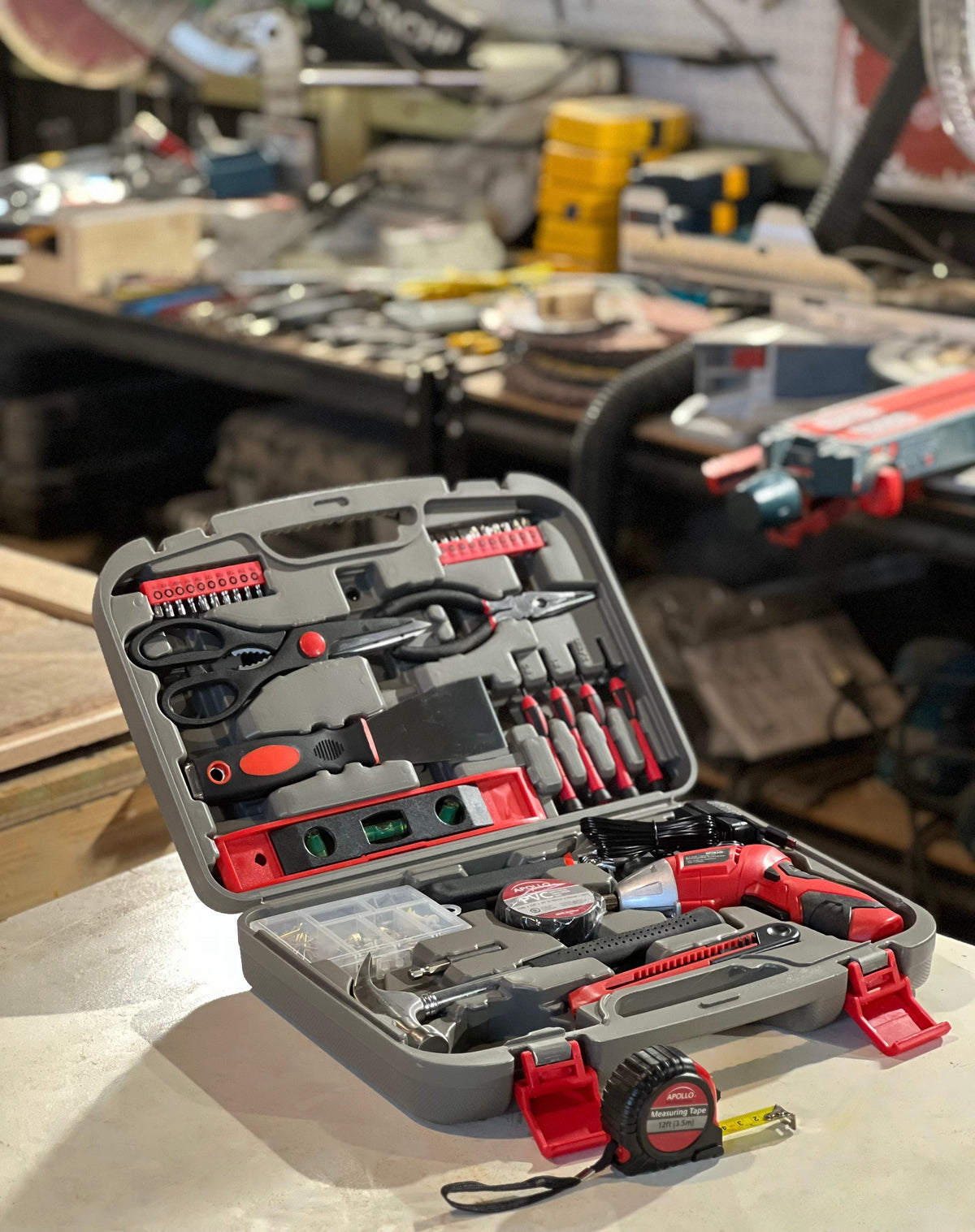 135 piece household tool set with cordless screwdriver and organized carrying case in workshop setting