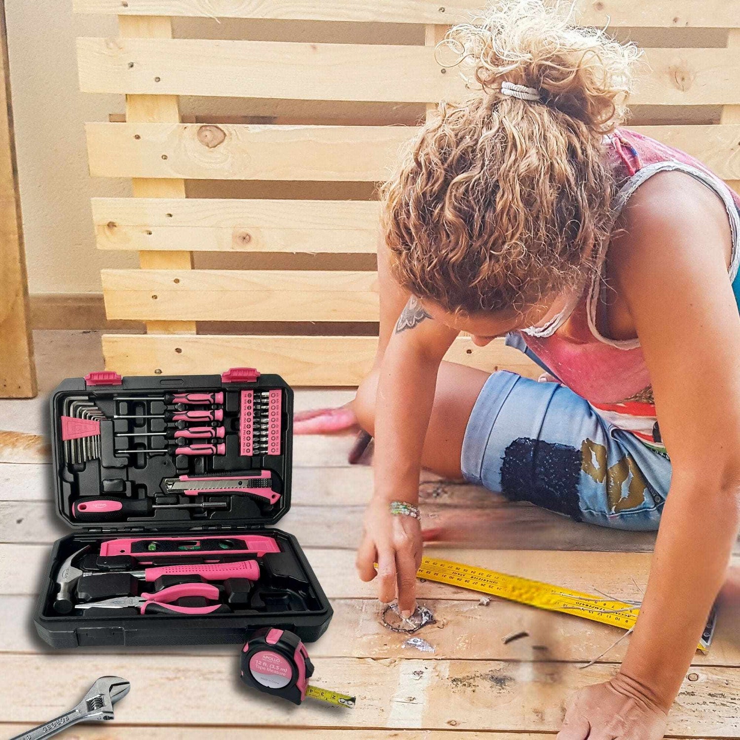 Pink tool set in black storage case with various hand tools for DIY home repairs