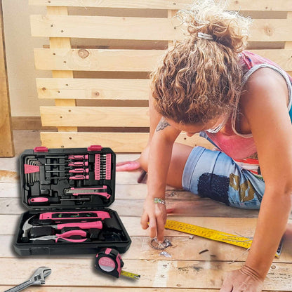 Pink tool set in black storage case with various hand tools for DIY home repairs