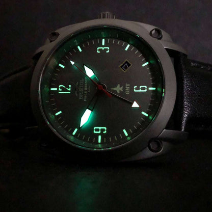 F-18 Hornet tribute watch with gunmetal finish, gray dial, glowing hands, and black leather strap