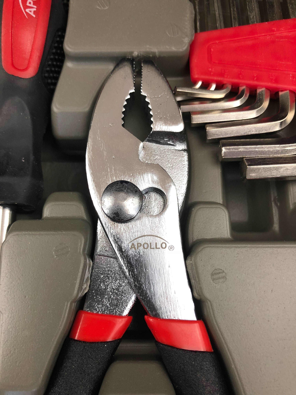 Close-up of Apollo 39 Piece General Tool Set pliers with red and black handle in storage case