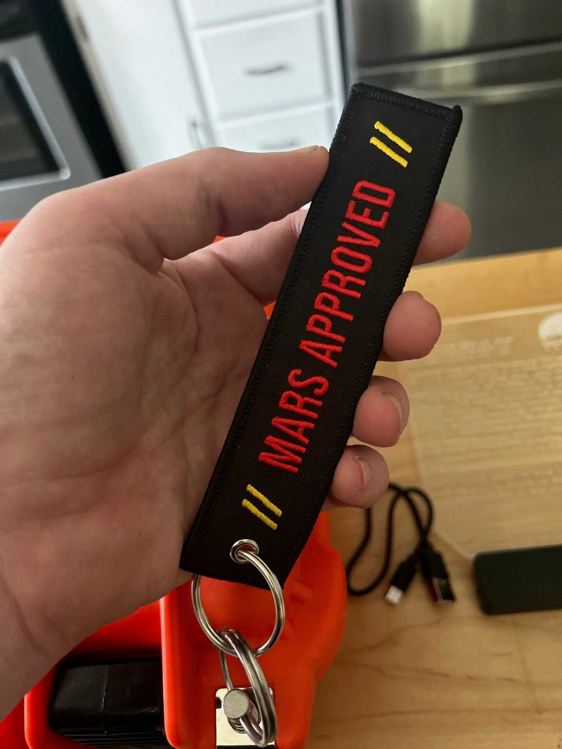 Mars Approved Flight Tag embroidered keyring with red lettering and metal grommet