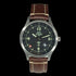 P-51 Mustang Tribute watch with stainless steel brushed case, brown leather strap, and black dial featuring Swiss quartz movement and WWII aircraft artifact back