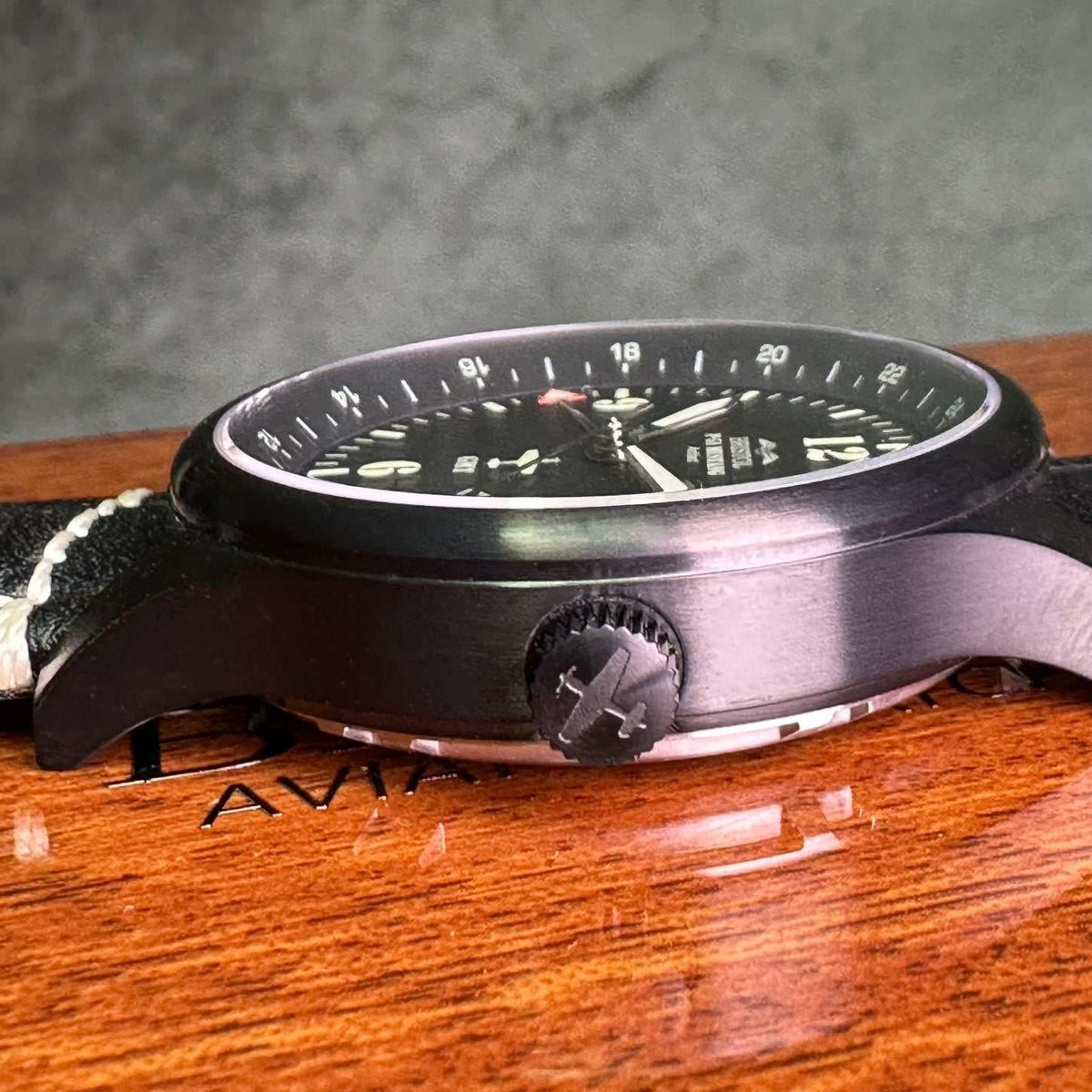 P-51 Mustang tribute watch with black finish, black leather band, sapphire crystal, and Swiss quartz movement featuring GMT and date functions.