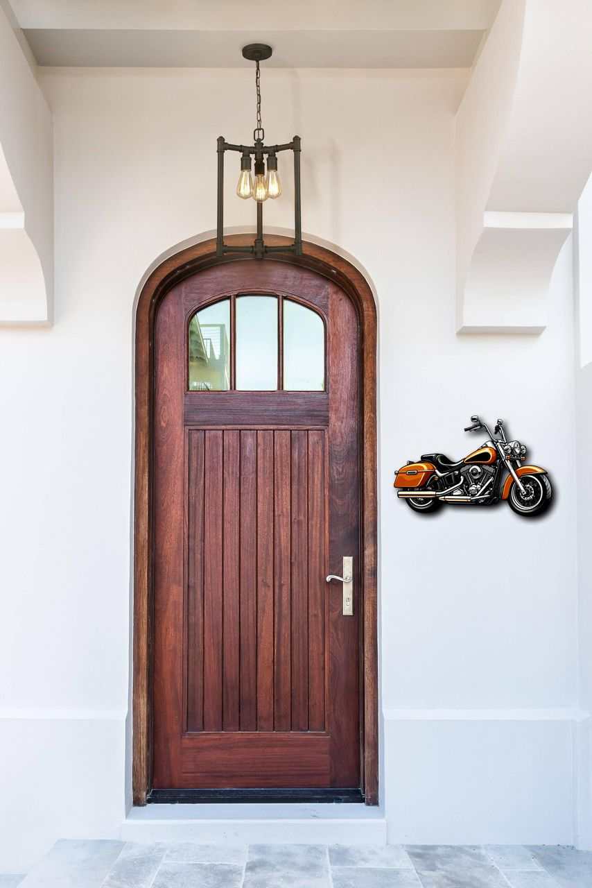 Motorcycle metal wall art mounted next to wooden door outdoor decor