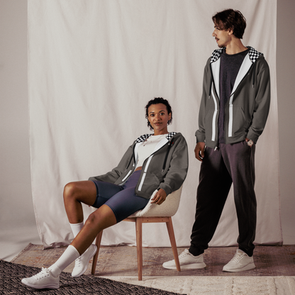 Unisex sustainable aviation hoodie in gray with checkered hood lining, worn by male and female models indoors