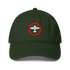 Dark green aviation low-profile baseball cap with embroidered white airplane inside red circle on front, adjustable strap and pre-curved visor.