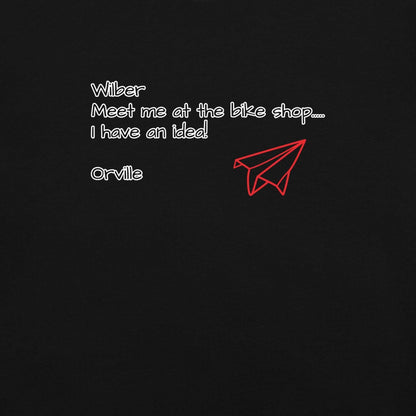 Bike Shop Wilbur black t-shirt with white text and red paper airplane graphic, 100% ring-spun cotton, heavyweight breathable fabric