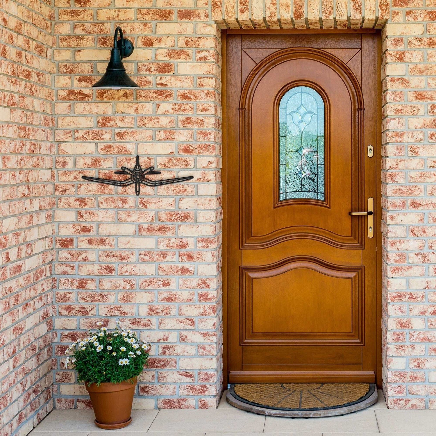 F4U Corsair metal sign aircraft silhouette mounted on brick wall near wooden door