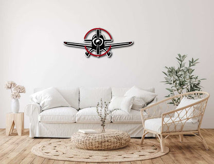 Multicolor metal sign of a propeller plane mounted on living room wall above white sofa