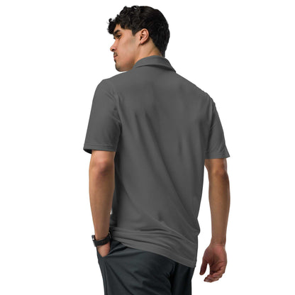 Man wearing black pilot polo shirt with embroidered private jet logo on chest, performance fit, short sleeves, and collared design