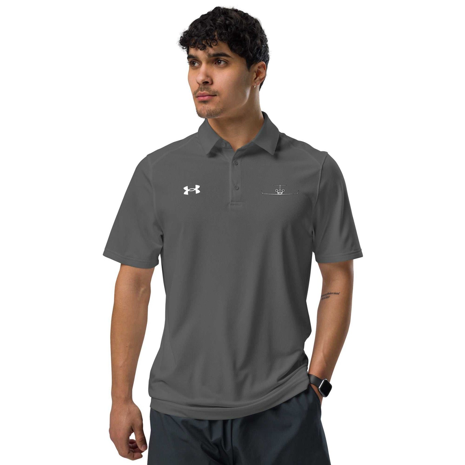 Man wearing dark gray polo shirt with embroidered private jet logo and Under Armour logo, short sleeve golf and travel performance fit shirt