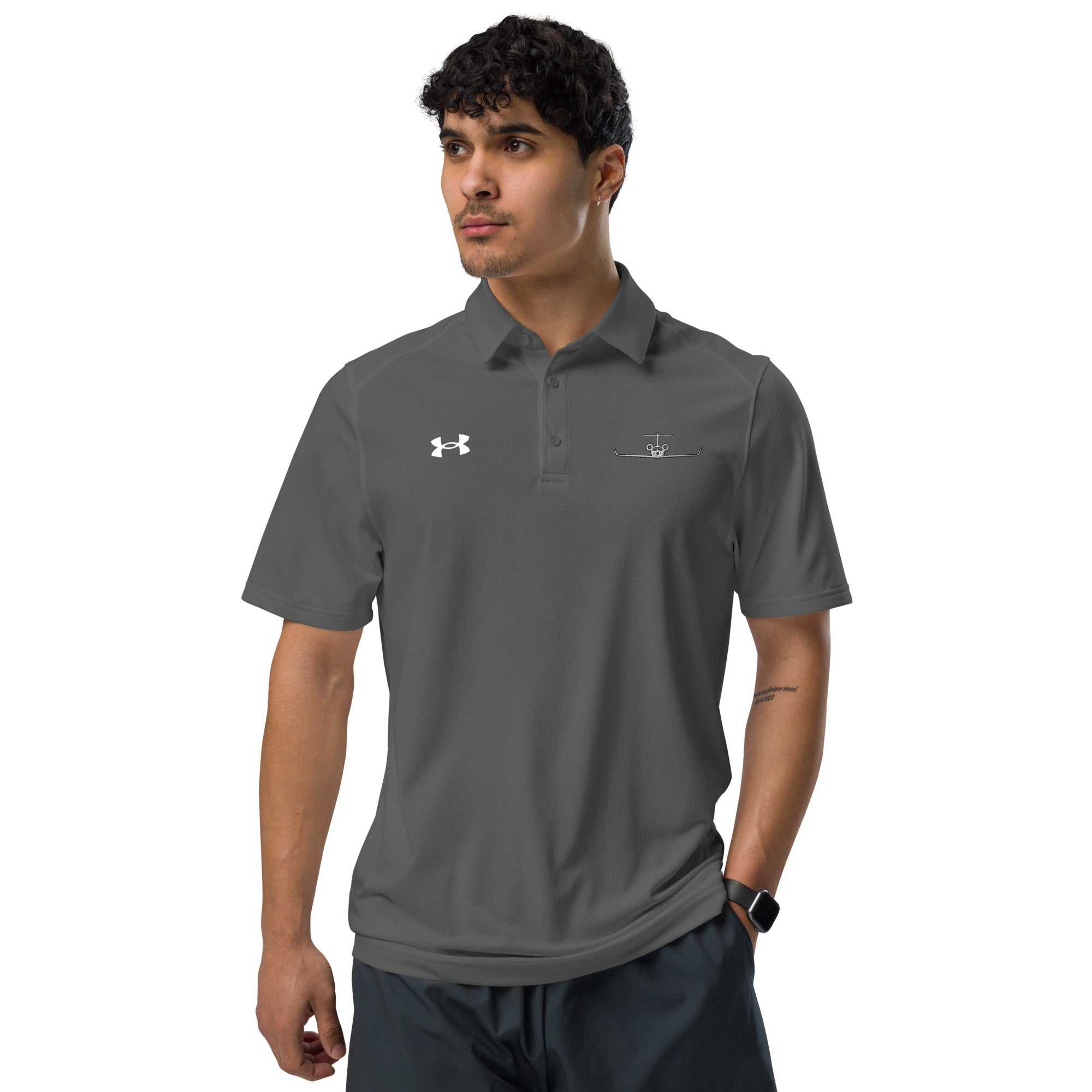 Man wearing dark gray polo shirt with embroidered private jet logo and Under Armour logo, short sleeve golf and travel performance fit shirt