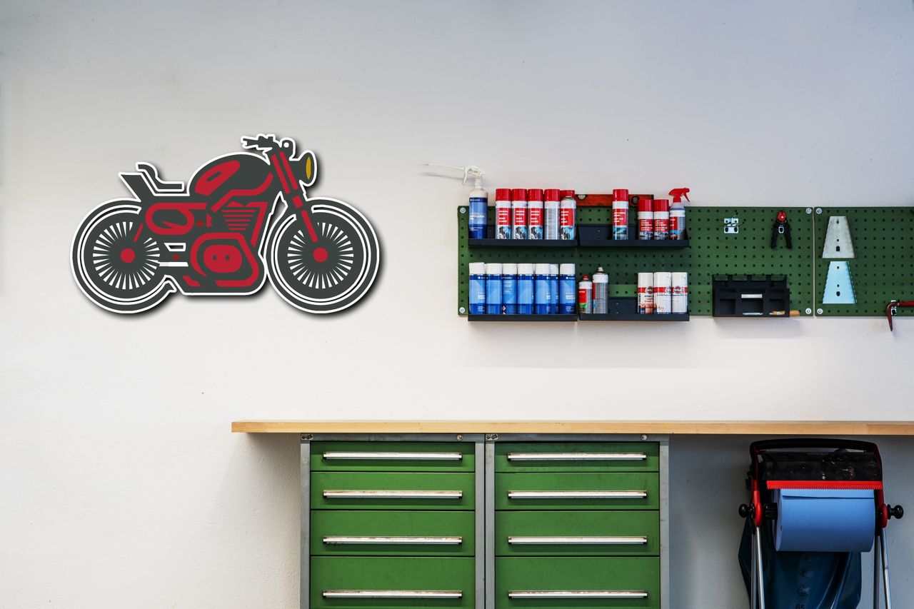 Motorcycle Metal Wall Art in red and black metal design mounted on wall in garage workspace