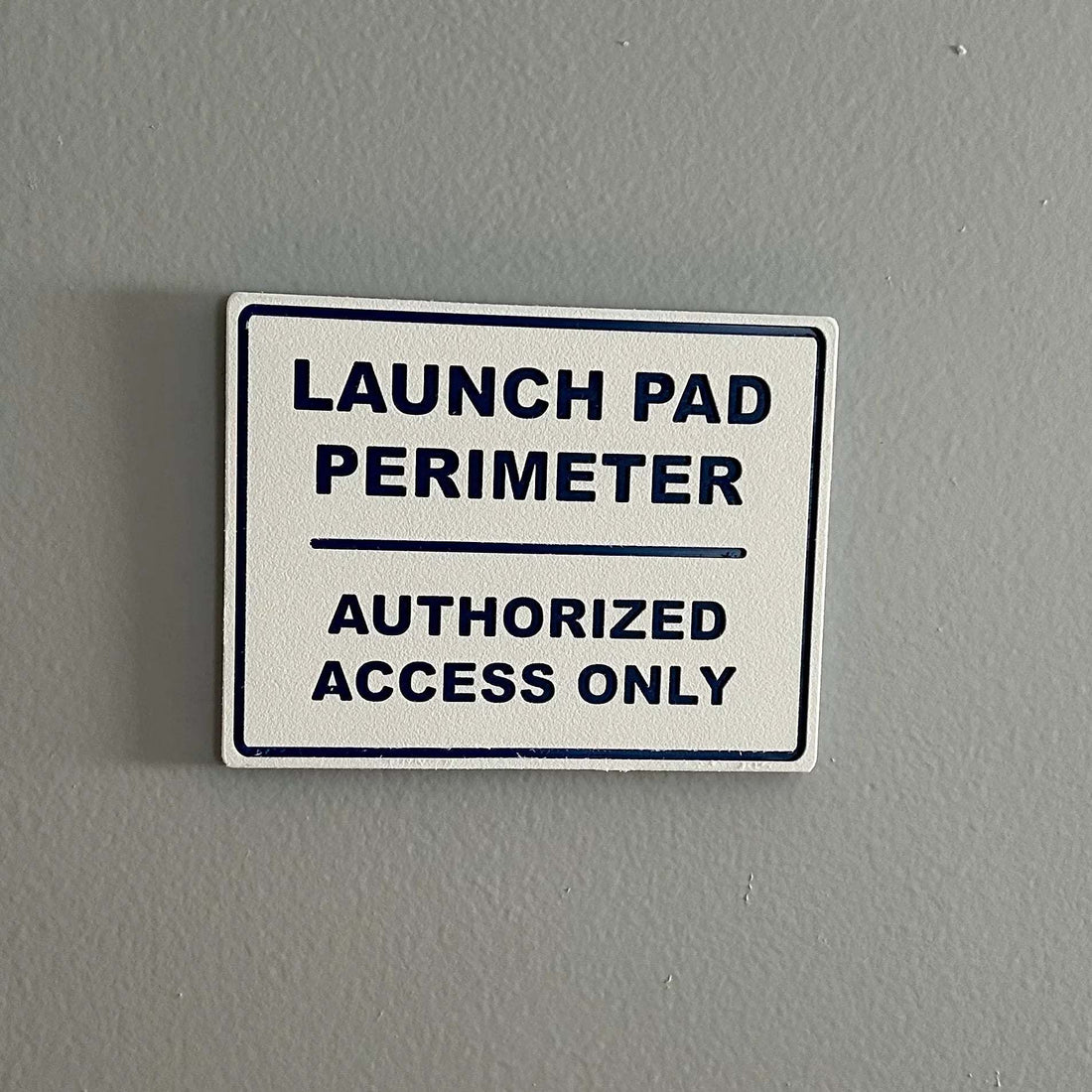 Launch Pad Perimeter high-impact wall sign with bold lettering for garages and workshops