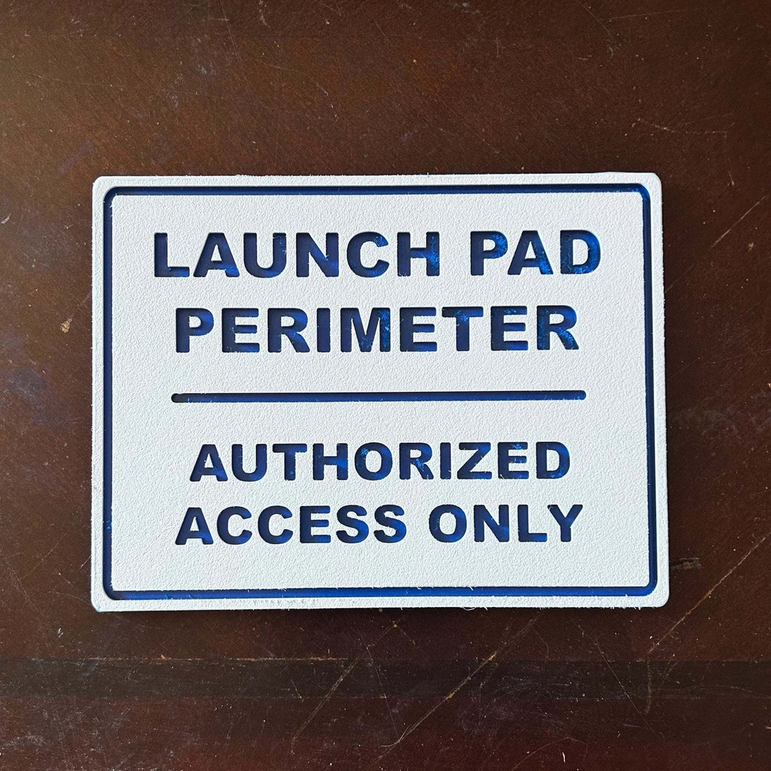 Launch Pad Perimeter wall sign with bold lettering for garages and workshops