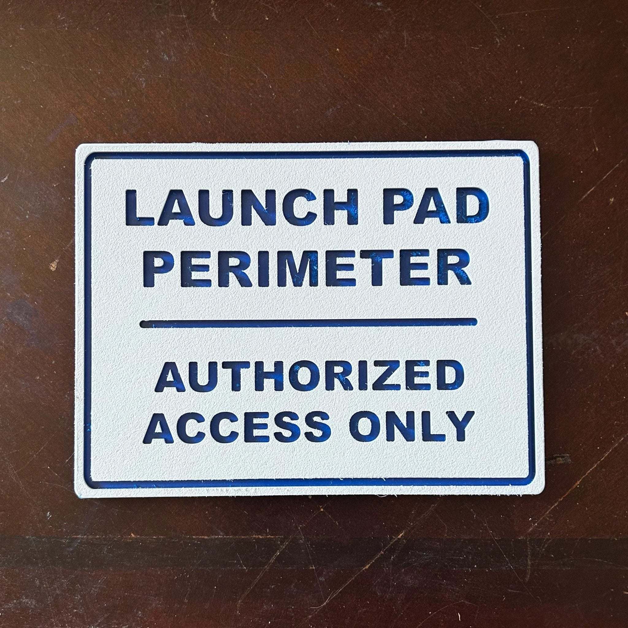 Launch Pad Perimeter wall sign with bold lettering for garages and workshops