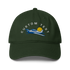 Green cap with airplane and sun design on a white background