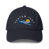 Navy blue cap with airplane and sun design on a white background