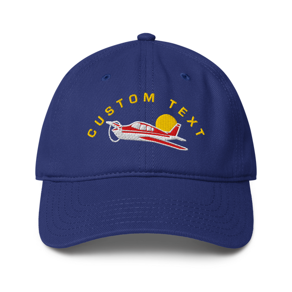 Blue cap with airplane design and 'CUSTOM TEXT' text on a white background