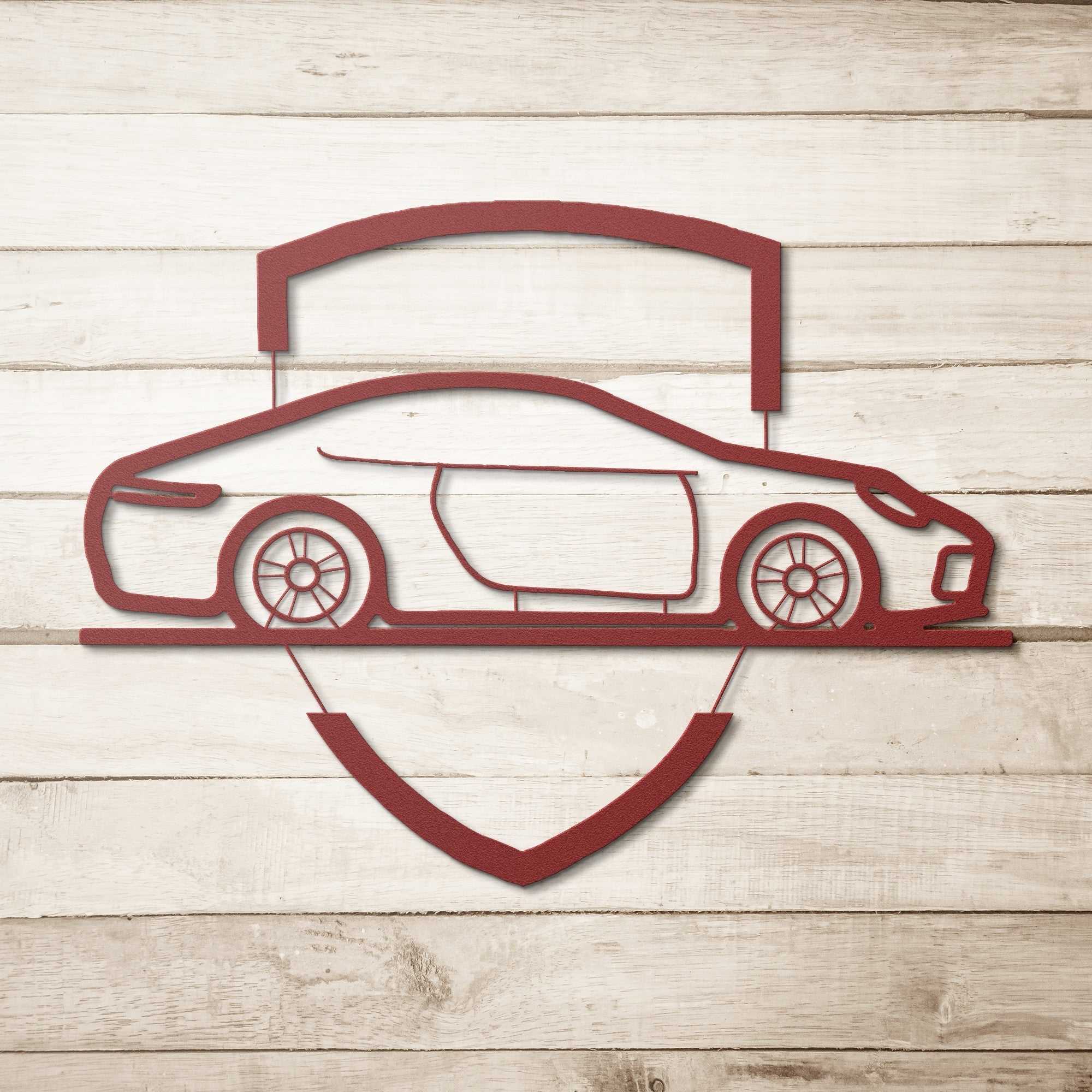 Elegant metal sign with red car emblem on wooden background