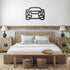 metal wall art car silhouette above wooden bed in modern bedroom