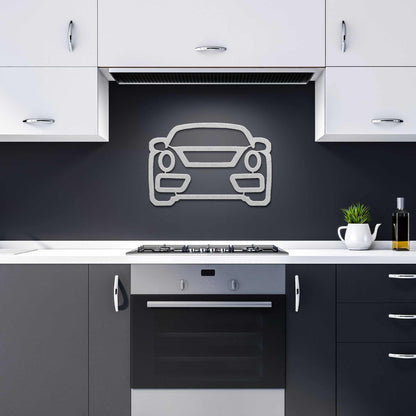 Modern metal wall art car design mounted on kitchen backsplash above stove
