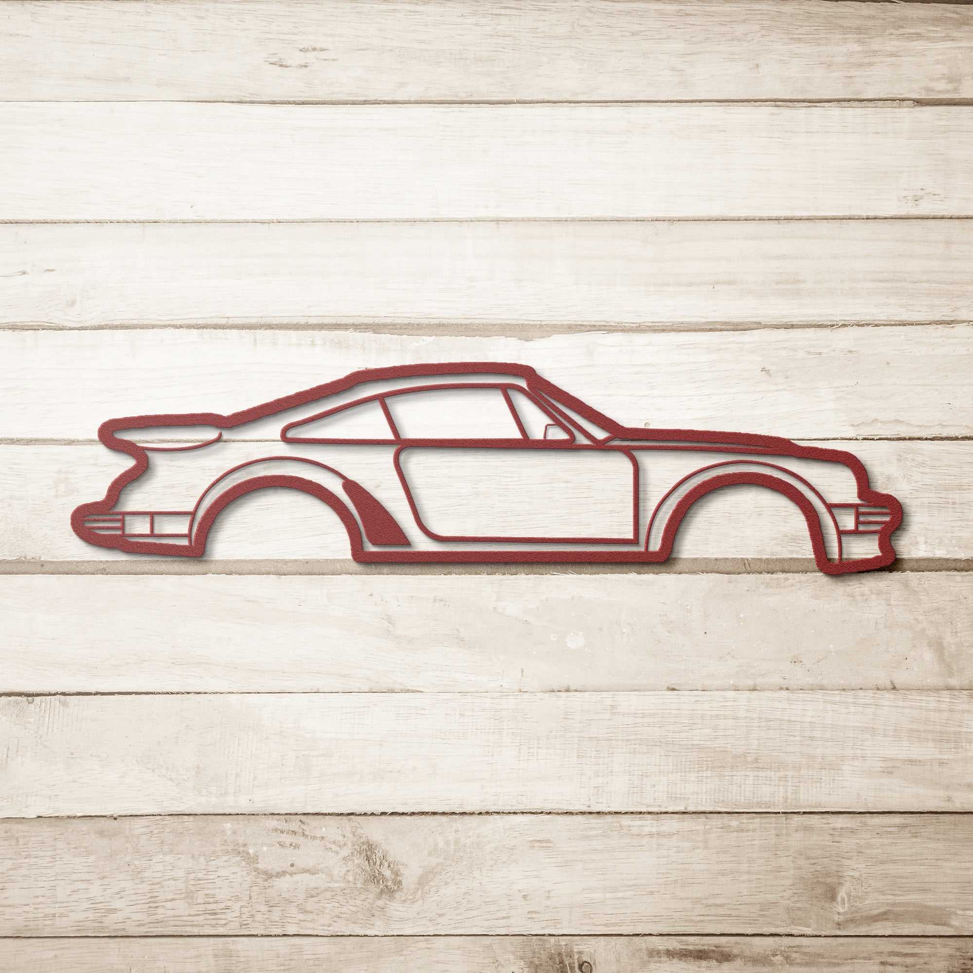 Metal Wall Art Nine Thirty Silhouette car design in red powder-coated steel on wooden background