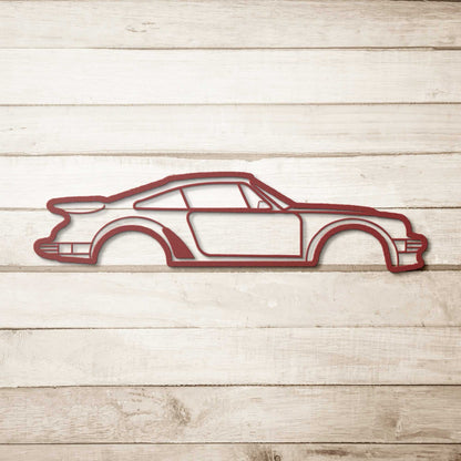 Metal Wall Art Nine Thirty Silhouette car design in red powder-coated steel on wooden background