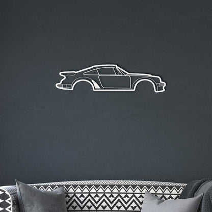 Minimalist metal wall art silhouette of a car in white powder-coated steel on dark wall