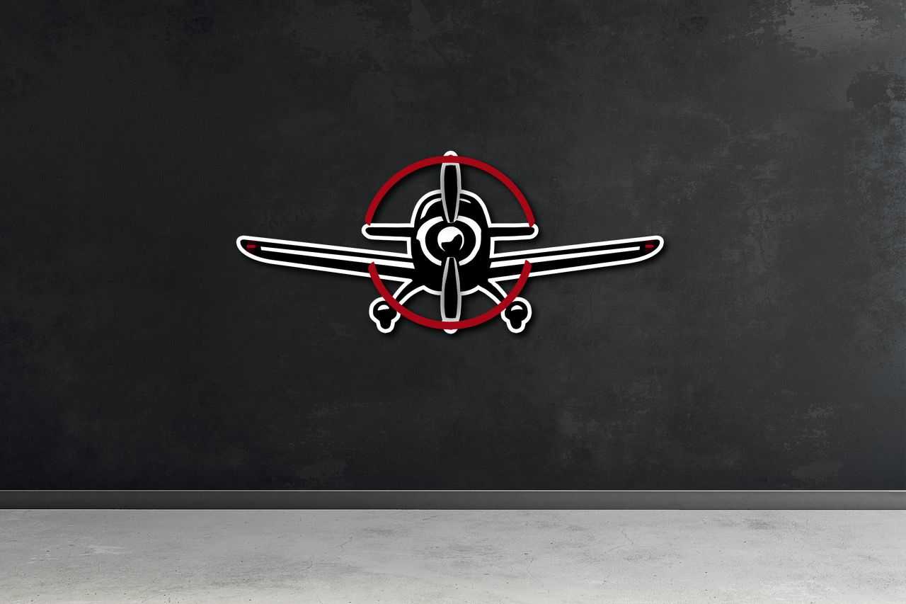 Multicolor metal sign shaped like a propeller airplane mounted on a dark wall