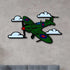 Multicolor metal sign featuring a green Spitfire airplane with clouds, made of durable 16-gauge steel for indoor and outdoor wall decor