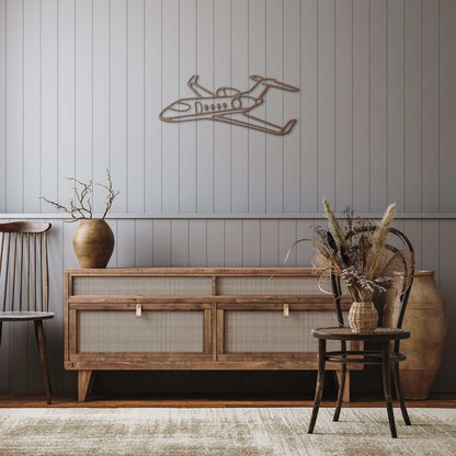 Elegant metal sign featuring a private jet design mounted on a gray paneled wall above wooden sideboard in a cozy room