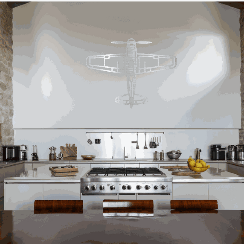 Retro airplane metal wall art decoration in a modern kitchen with stainless steel appliances