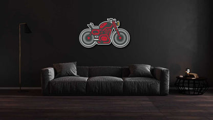 Motorcycle metal wall art featuring a red and black motorcycle design mounted above a modern dark gray sofa in a minimalist living room with dark walls.