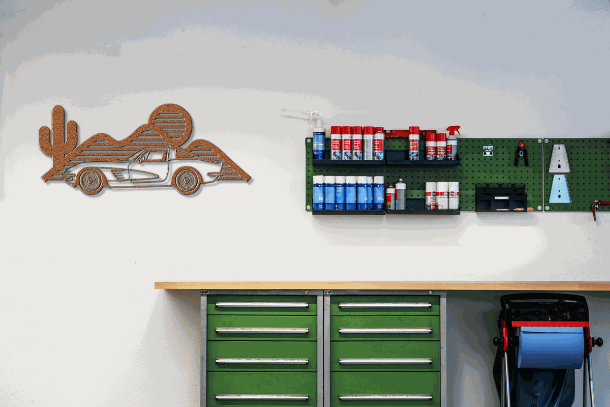 Laser-cut Corvette silhouette wall art in powder-coated steel, ideal for garages and showrooms.
