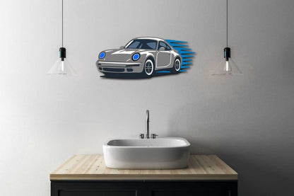 Garage wall decor steel art featuring a multicolor performance coupe silhouette mounted above a bathroom sink