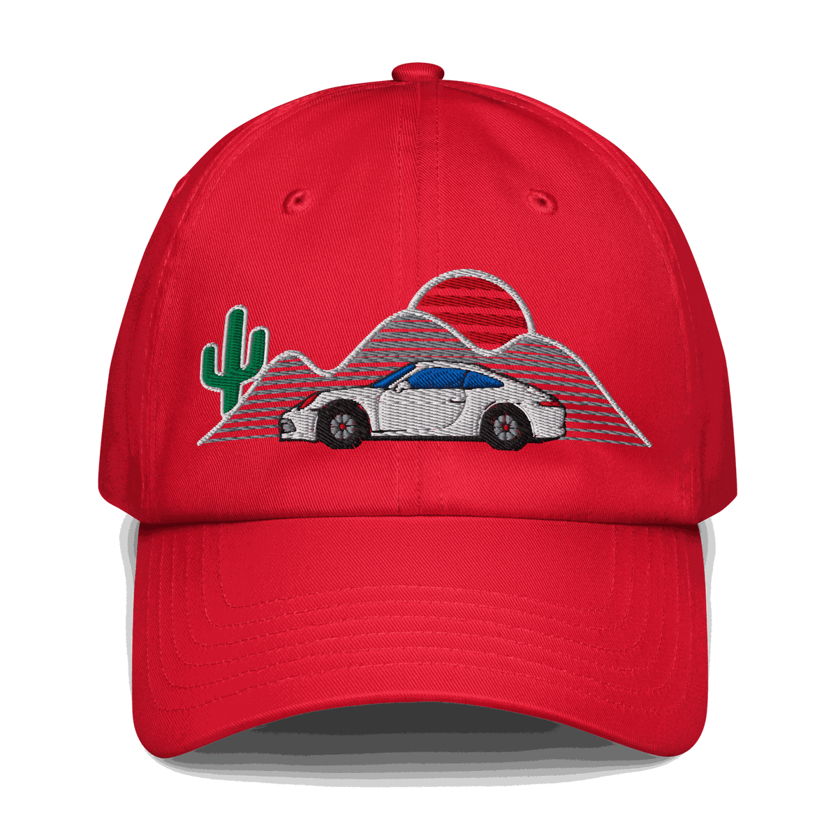 Red baseball hat with embroidered retro classic car, sunset, cactus, and mountain design.