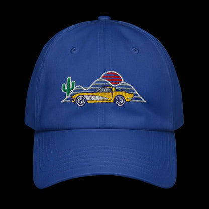 Blue baseball hat with a yellow corvette and cactus mountain sunset background