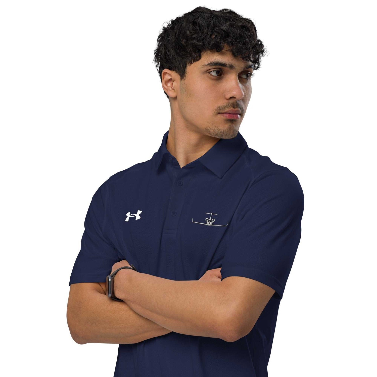 Man wearing navy pilot polo shirt with embroidered private jet logo and Under Armour logo on chest