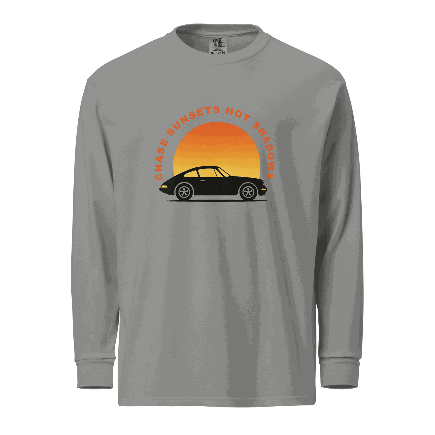 Gray garment-dyed long sleeve shirt with vintage car and sunset graphic and text "Chase sunsets not shadows"
