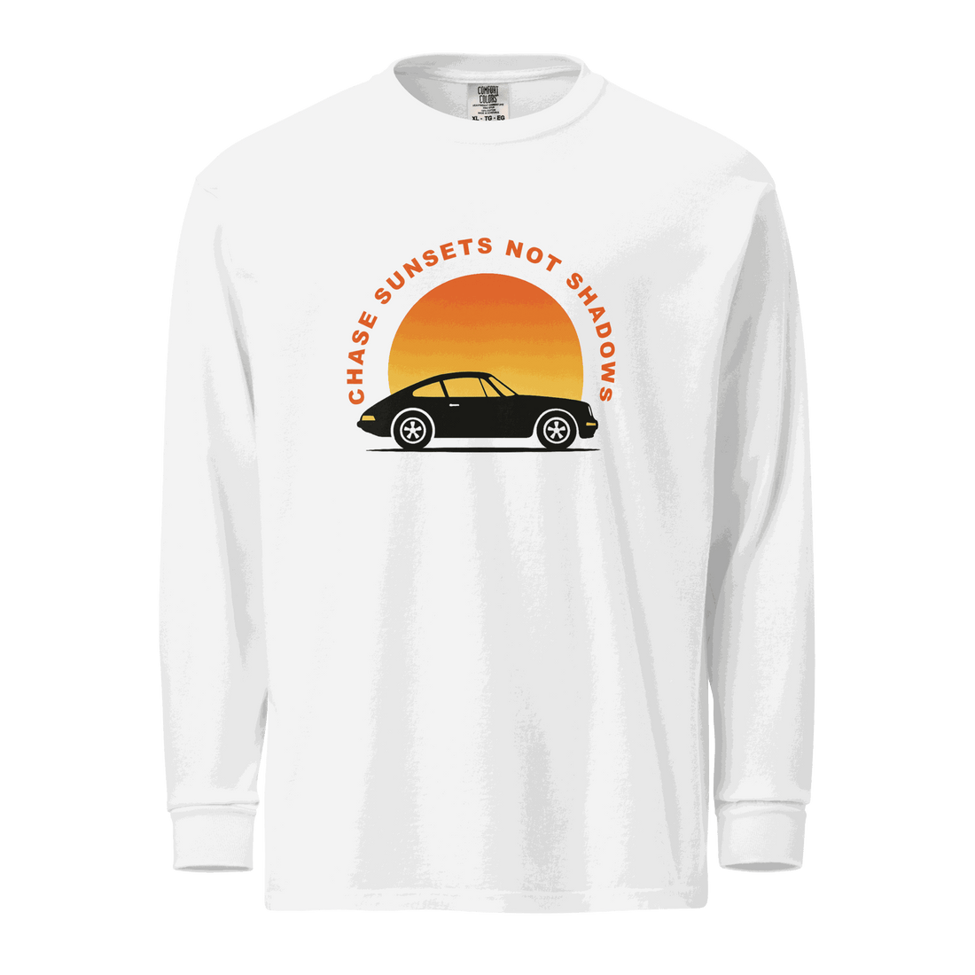 White garment-dyed long sleeve shirt with vintage car and sunset graphic and "Chase Sunsets Not Shadows" text