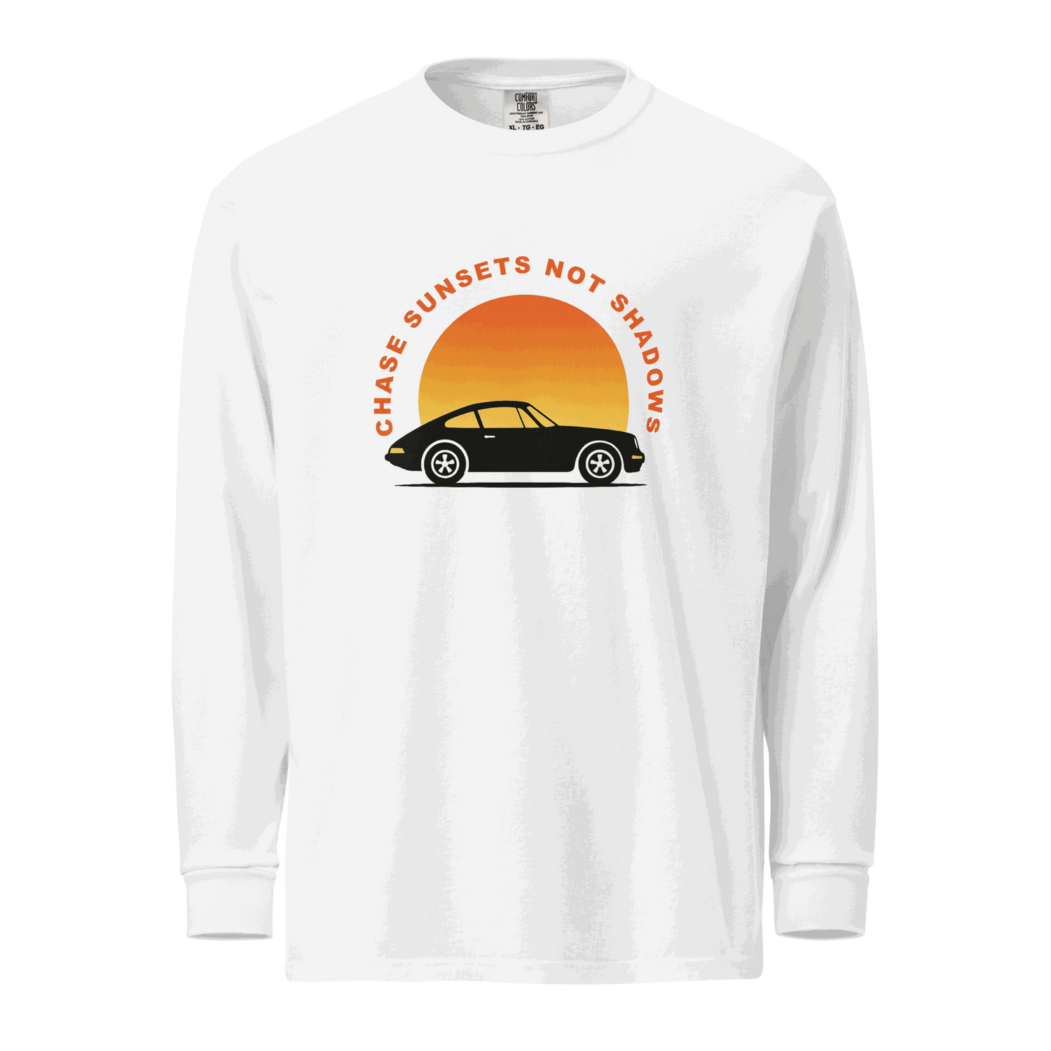 White garment-dyed long sleeve shirt with vintage car and sunset graphic and "Chase Sunsets Not Shadows" text