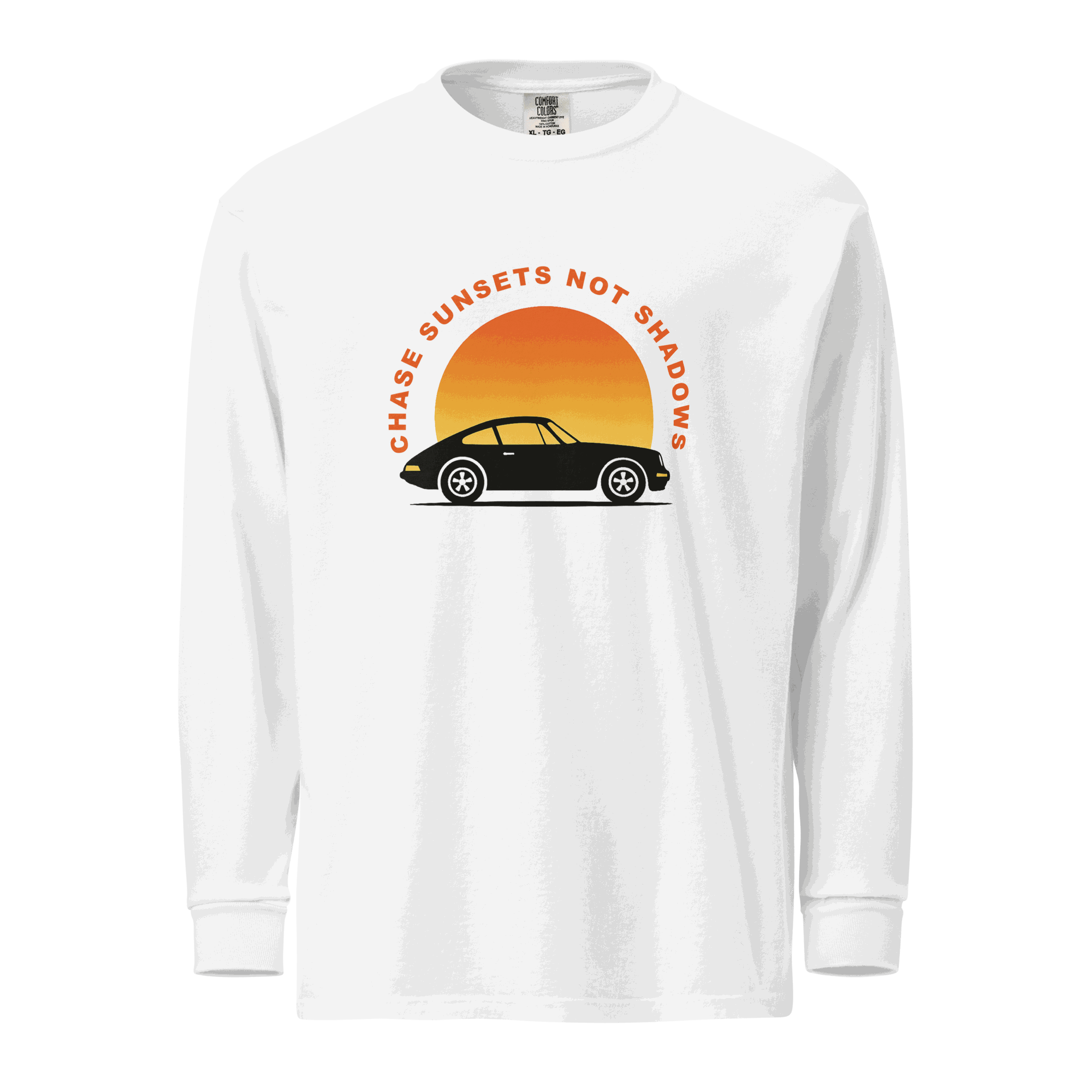 White garment-dyed long sleeve shirt with vintage car and sunset graphic and "Chase Sunsets Not Shadows" text