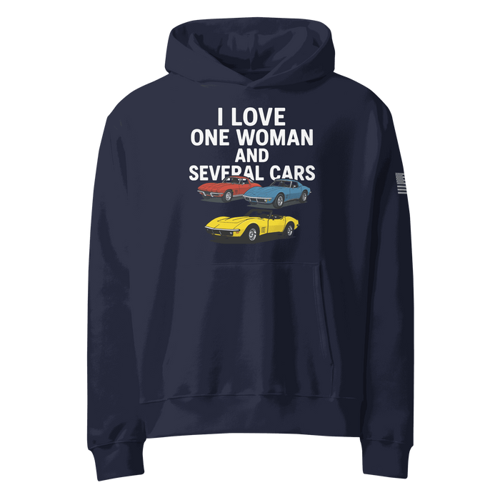 Woman wearing oversized heavyweight hoodie standing near several cars