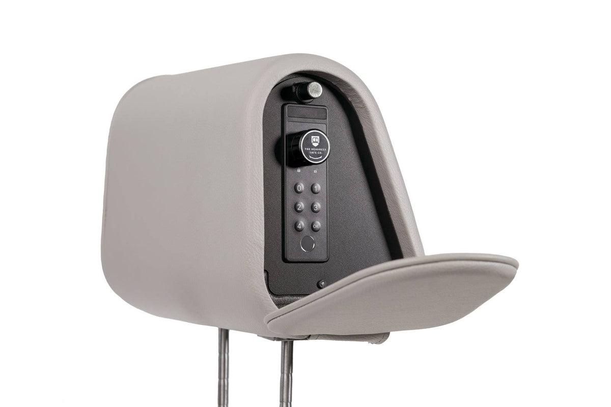 The Vulcan Headrest Safe steel lockbox installed on a truck seat with biometric and keypad security features